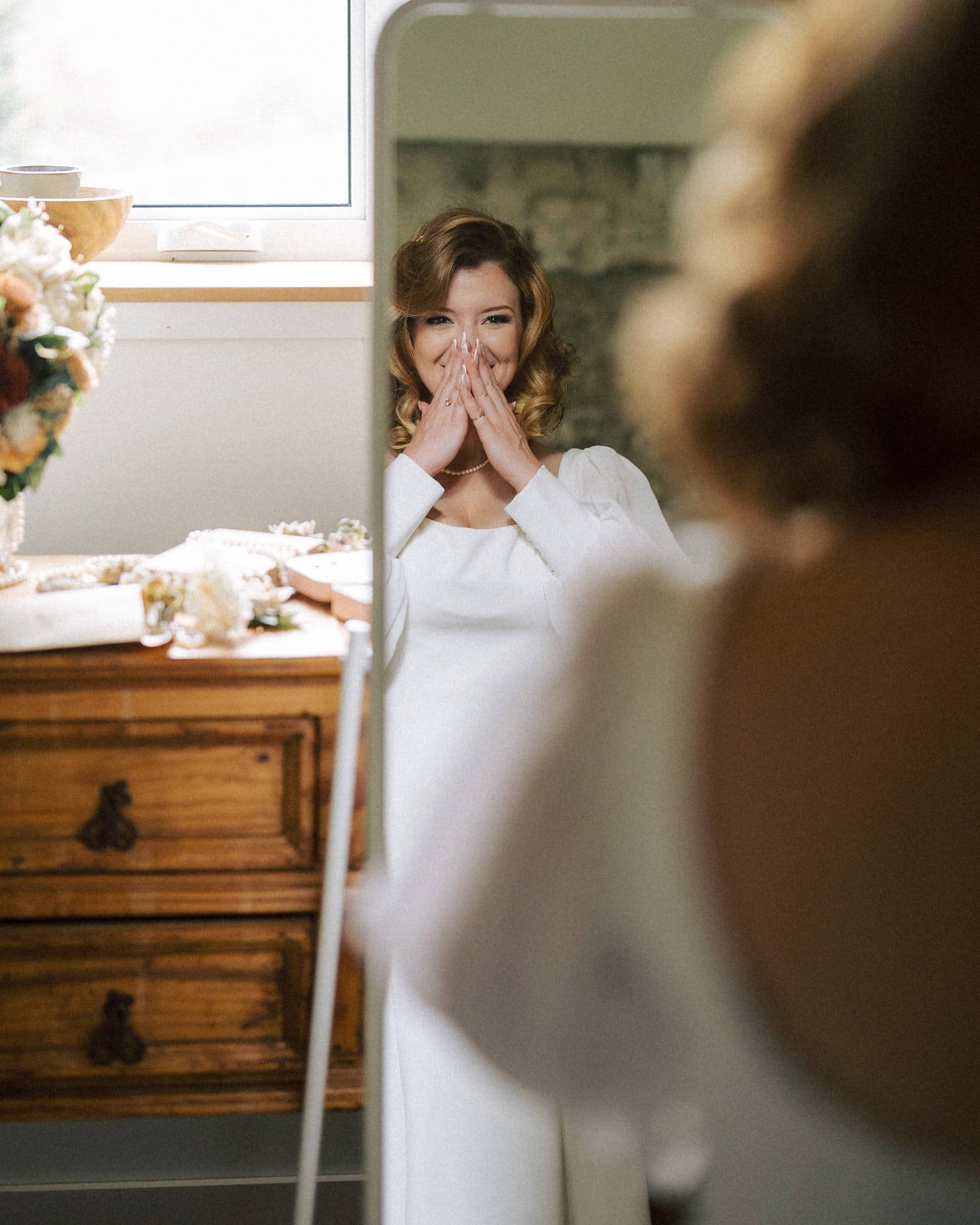 Bride looking in the mirror at 1920s-themed nostalgic Ancaster Mill wedding.
