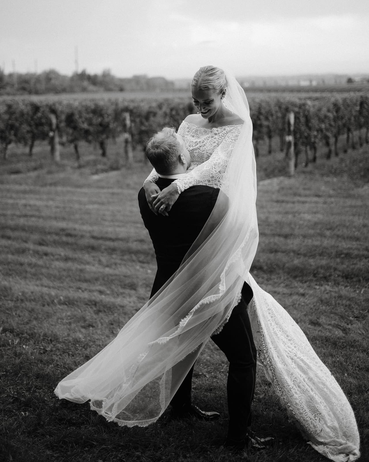 Bride and groom in the vineyard at Waupoos Estates Winery in PEC.