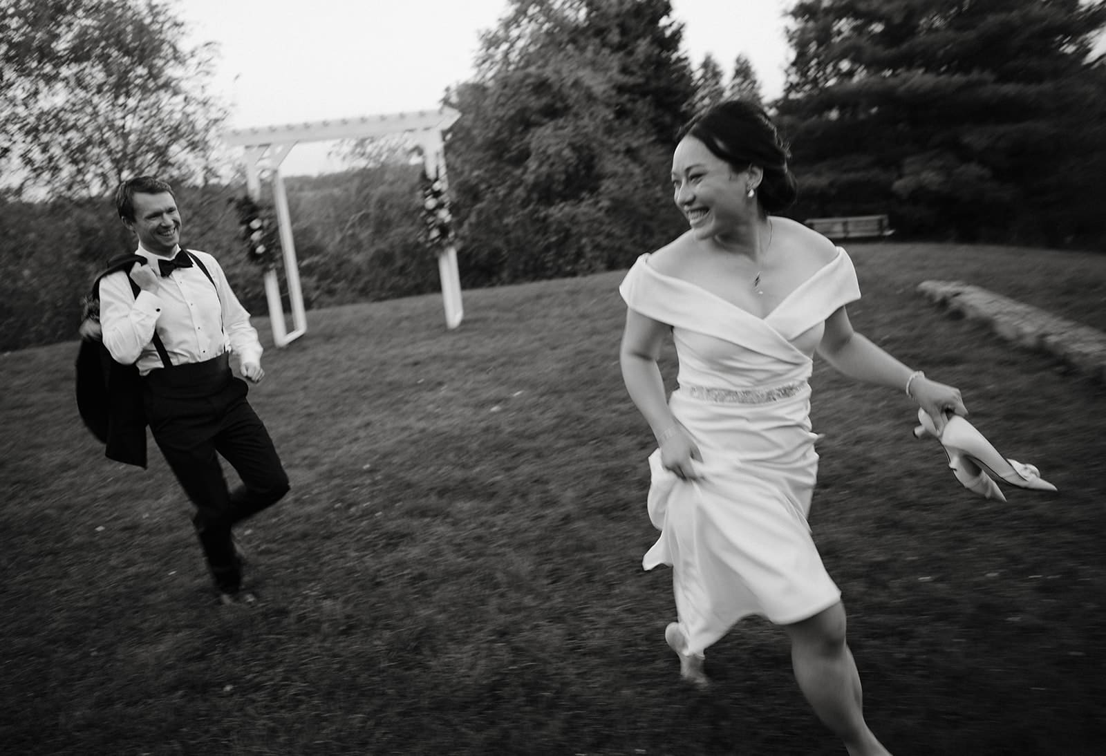 Bride and groom running at Compass Rose Suites wedding in PEC.