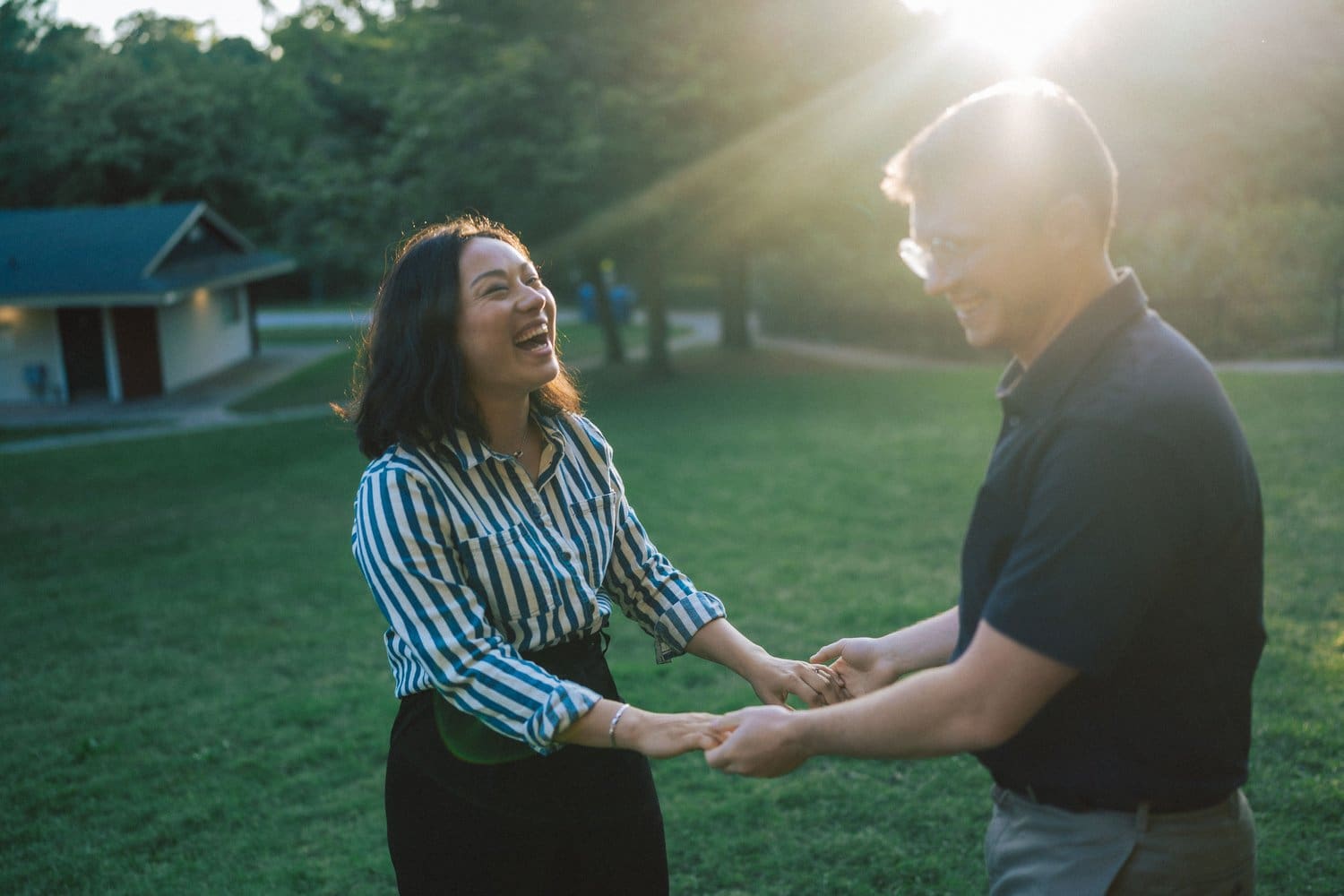 Couple laughing during High Park engagement session in Toronto, Ontario.